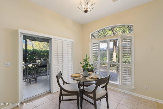 dining room featuring a chandelier and light tile patterned floors