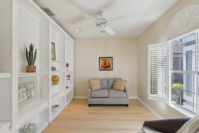 sitting room with light hardwood / wood-style flooring and ceiling fan