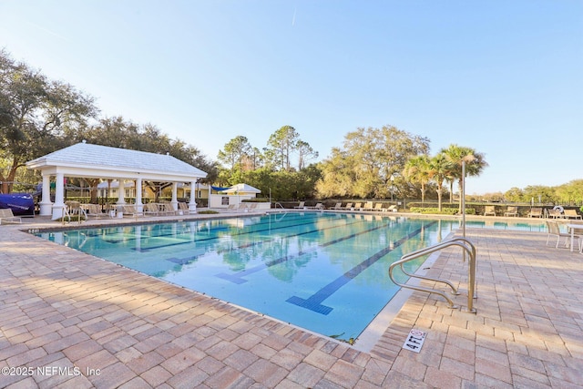 view of swimming pool featuring a patio and a gazebo