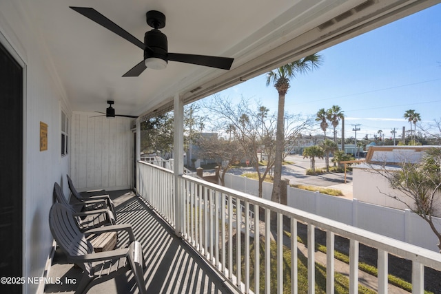 balcony with a porch and a ceiling fan