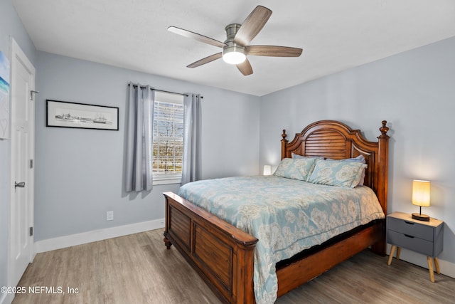 bedroom with light wood finished floors, ceiling fan, and baseboards