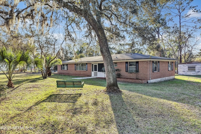 view of front of home with a front yard and brick siding