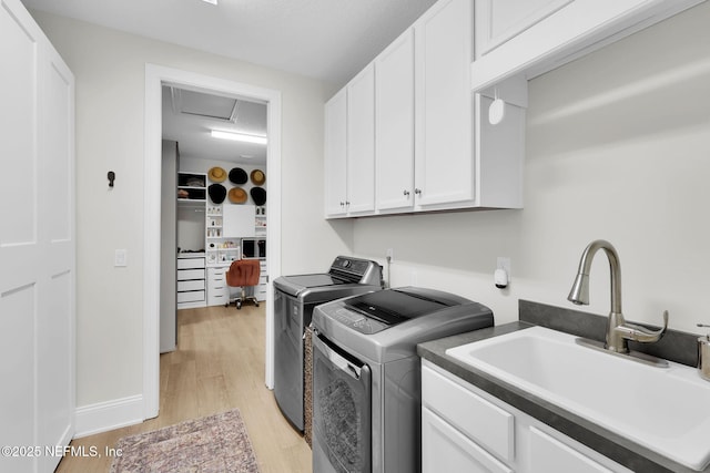 78 Cameron Dr, Ponte Vedra, FL 32081 - washroom featuring cabinet space, attic access, washing machine and clothes dryer, light wood-style floors, and a sink