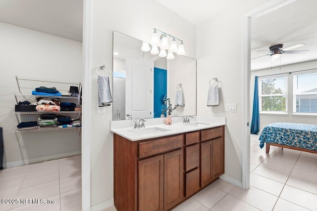 full bath with a sink, a ceiling fan, and tile patterned flooring