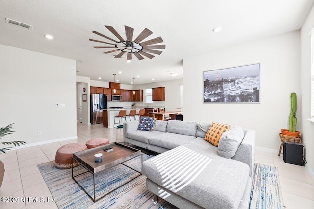 living area featuring light tile patterned flooring, visible vents, recessed lighting, and baseboards