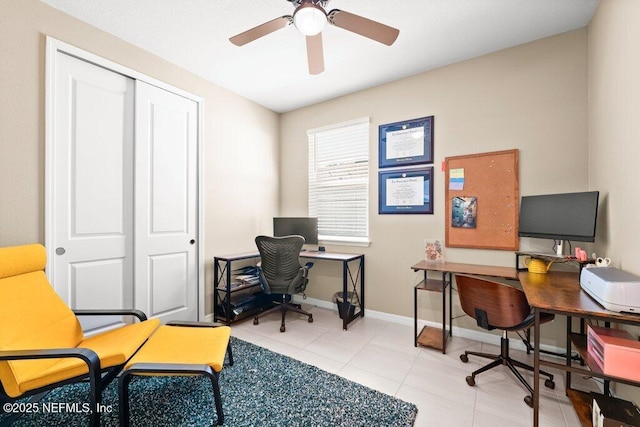 office with light tile patterned flooring, a ceiling fan, and baseboards