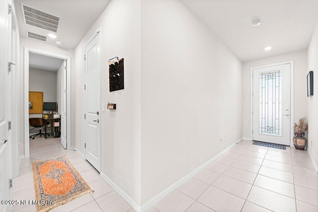 foyer entrance with light tile patterned floors and visible vents