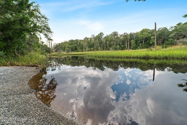 property view of water featuring a wooded view