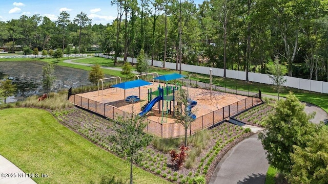 view of home's community featuring playground community, a lawn, and fence