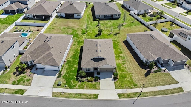 birds eye view of property with a residential view