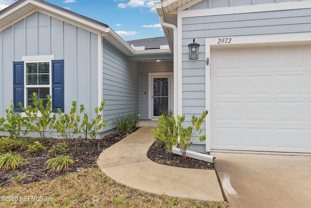 entrance to property featuring a garage and board and batten siding