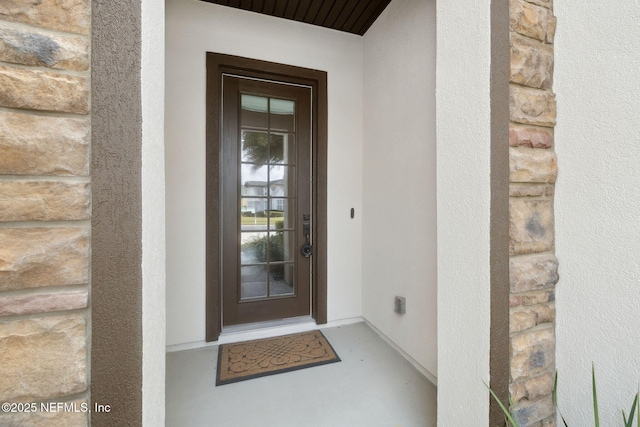 doorway to property with stucco siding