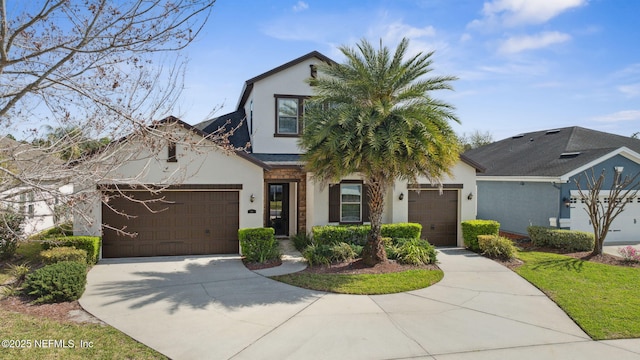 view of front of property with driveway, an attached garage, and stucco siding