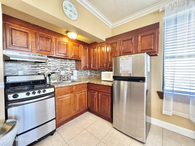 kitchen with sink, a textured ceiling, appliances with stainless steel finishes, crown molding, and light tile patterned flooring