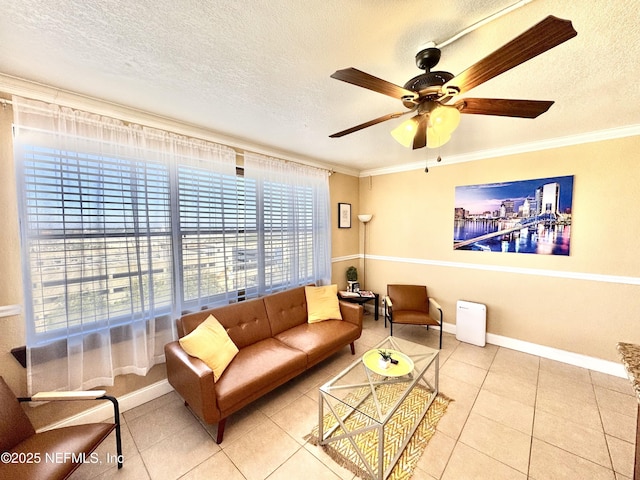 tiled living room with ceiling fan, crown molding, and a textured ceiling