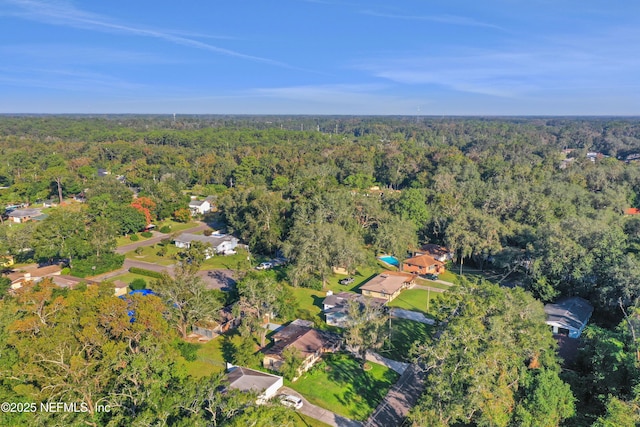 bird's eye view with a wooded view