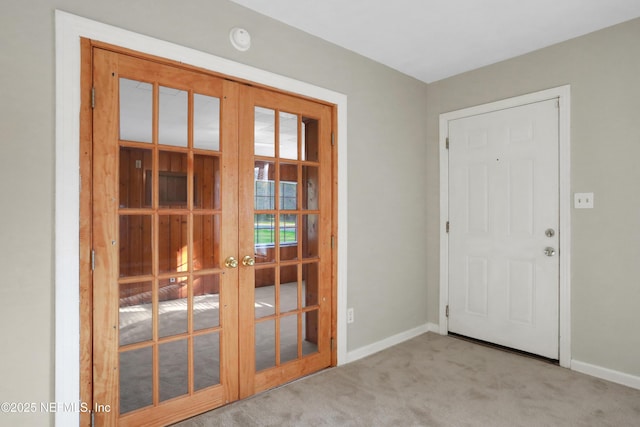 doorway to outside featuring baseboards, french doors, and light colored carpet