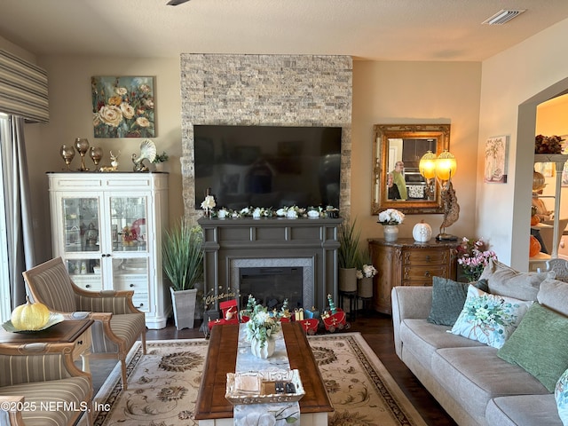 living room featuring hardwood / wood-style flooring, french doors, and a large fireplace