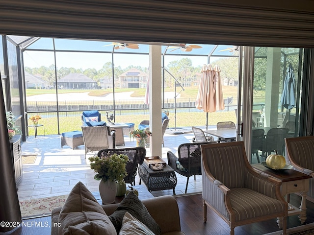 sunroom / solarium featuring ceiling fan