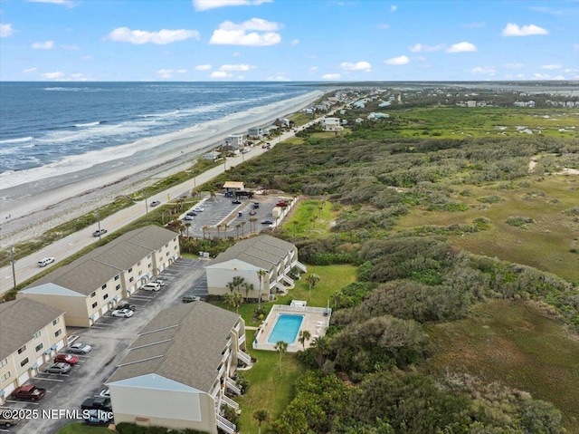 drone / aerial view featuring a water view and a view of the beach