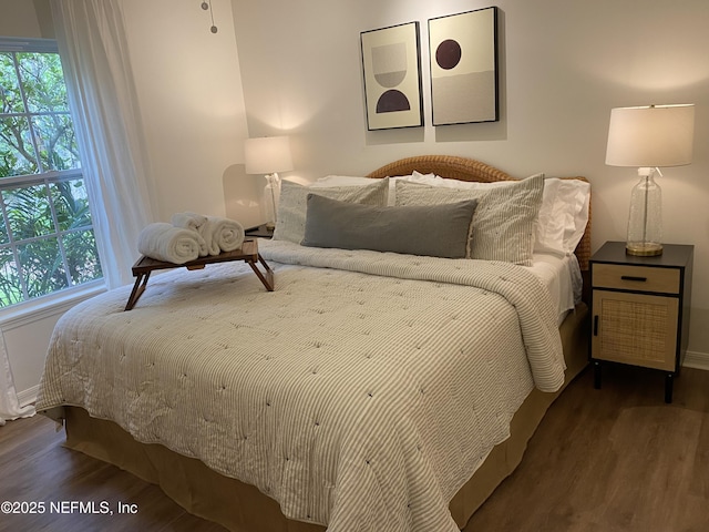 bedroom with wood finished floors and baseboards