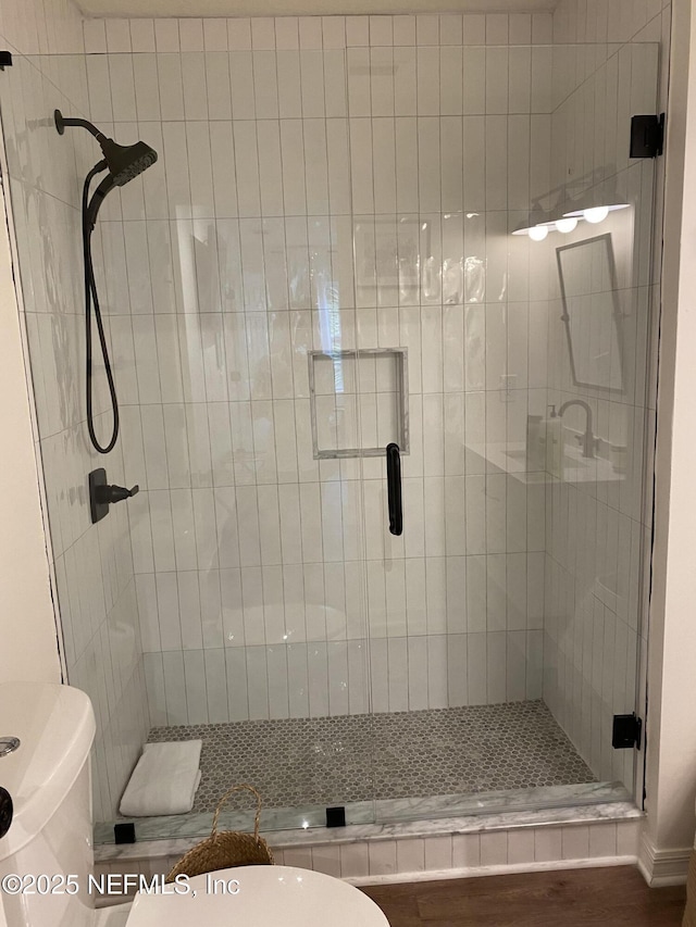 full bath with toilet and a stall shower