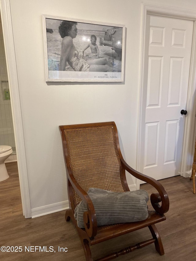 living area with wood finished floors and baseboards