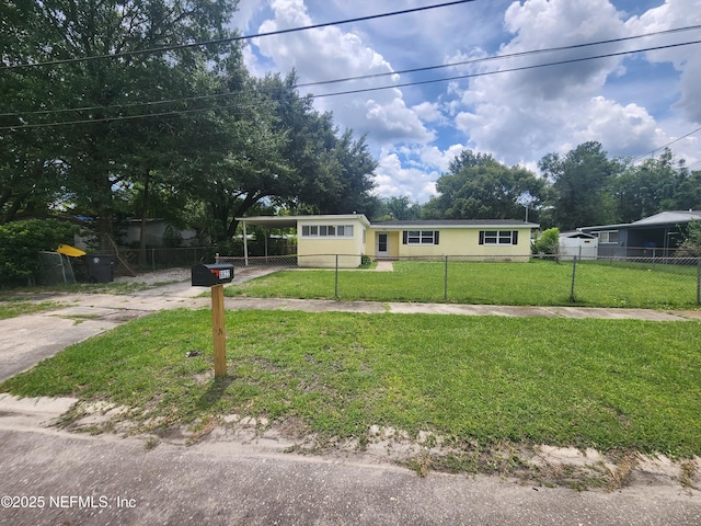 view of front of house with a fenced front yard, a front yard, driveway, and a carport