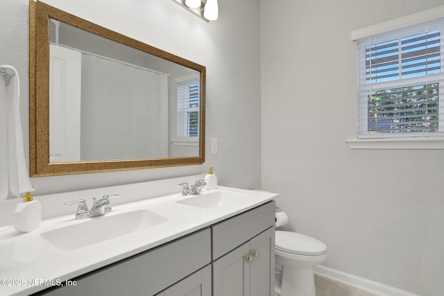 full bath with tile patterned flooring, a sink, toilet, and double vanity