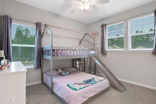 bedroom with carpet floors, multiple windows, and baseboards