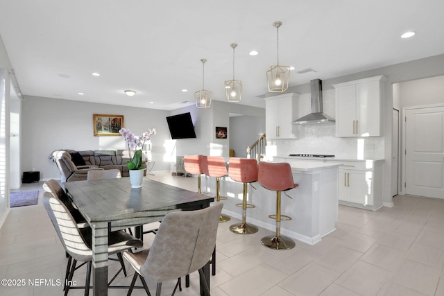 dining area featuring recessed lighting and stairway