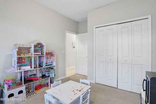 recreation room with carpet floors and baseboards