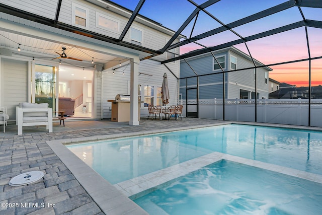 view of pool with a pool with connected hot tub, a patio, a lanai, and ceiling fan