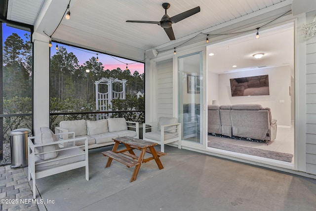 sunroom with a ceiling fan