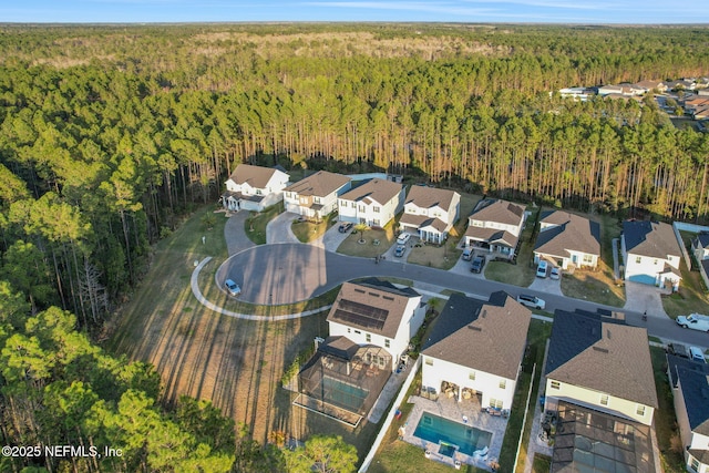 birds eye view of property with a forest view and a residential view