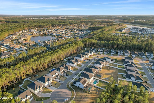 drone / aerial view featuring a water view and a residential view