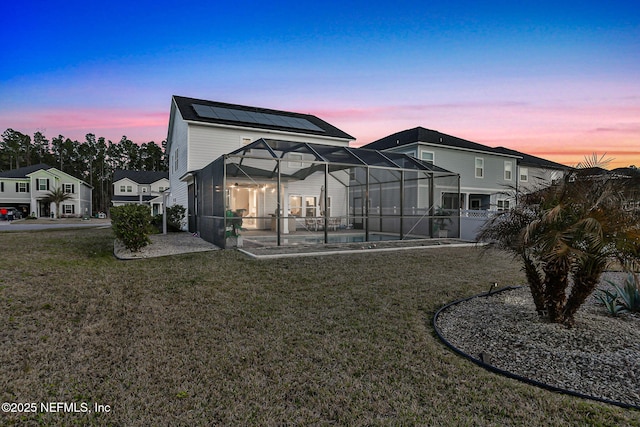 back of property featuring an outdoor pool, a lanai, a patio, and a lawn