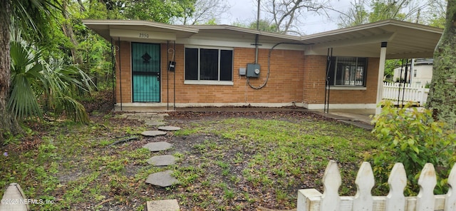 view of front of property with fence and brick siding