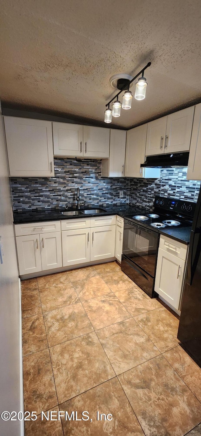 kitchen featuring dark countertops, black range with electric stovetop, backsplash, a sink, and under cabinet range hood