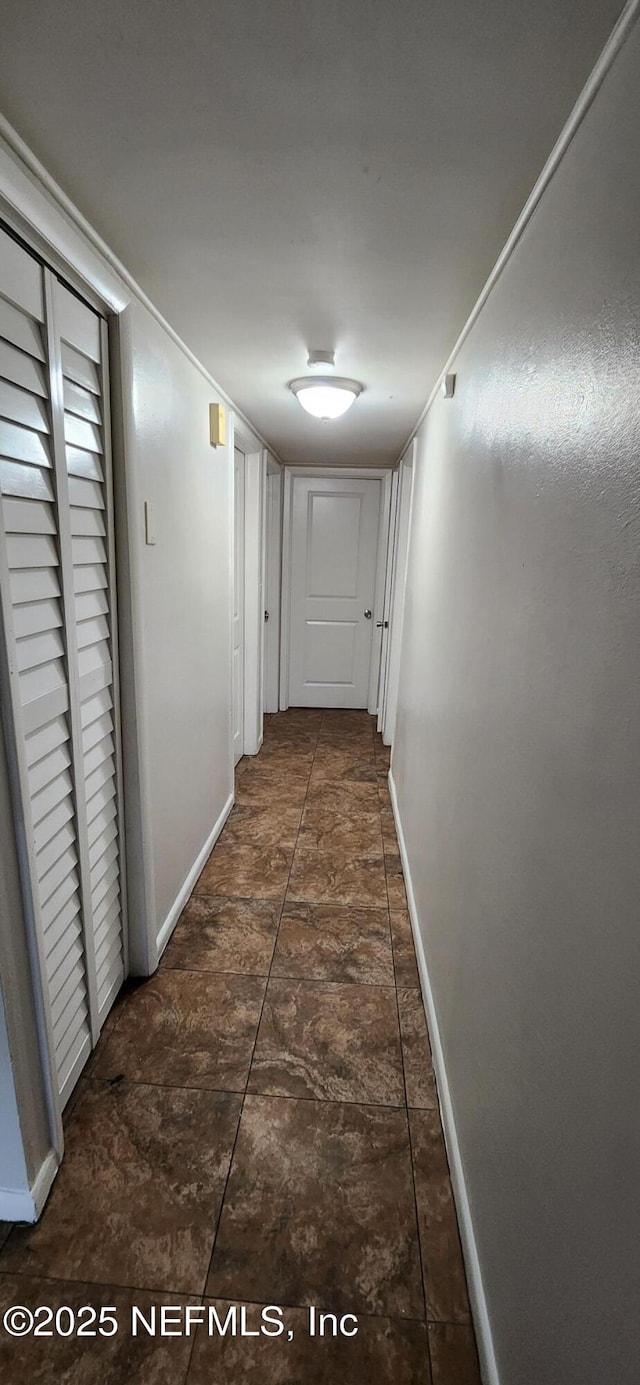 hallway featuring baseboards