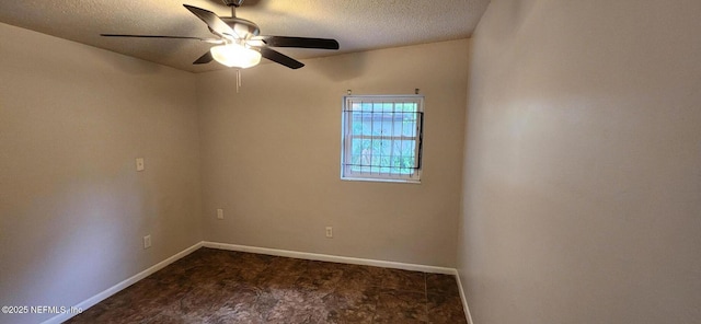 unfurnished room with a textured ceiling, ceiling fan, dark carpet, and baseboards