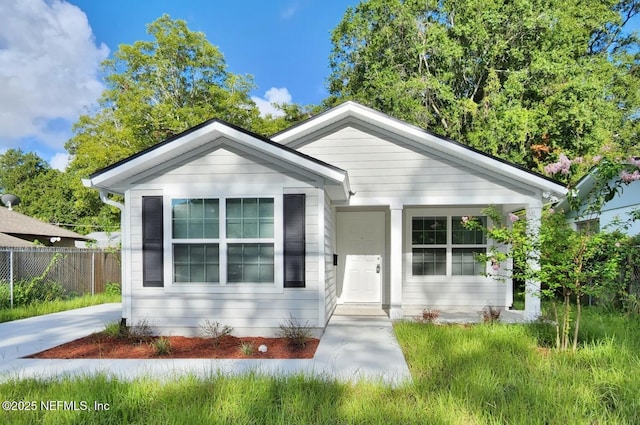 bungalow-style home featuring fence