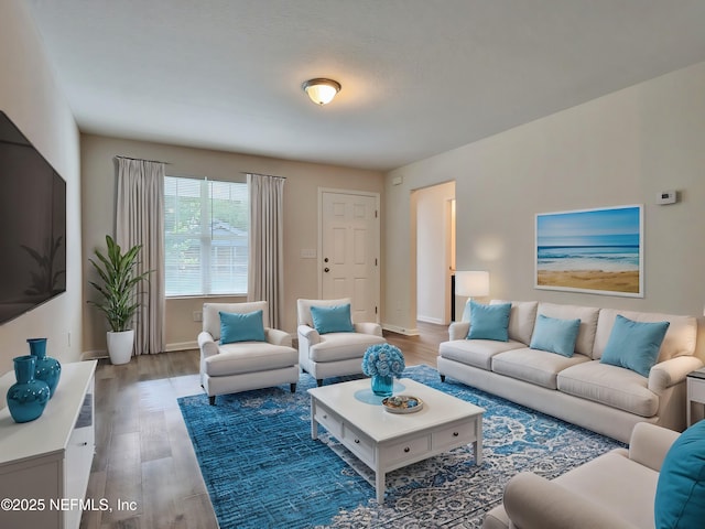 living area with wood finished floors and baseboards