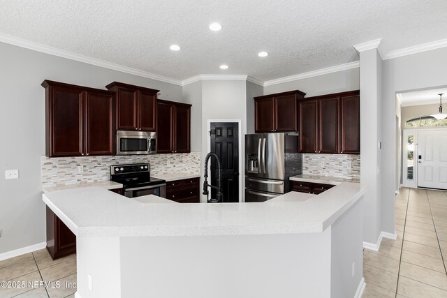 1465 Shadow Creek Dr, Orange Park, FL 32065 - kitchen with appliances with stainless steel finishes, ornamental molding, light tile patterned floors, and kitchen peninsula