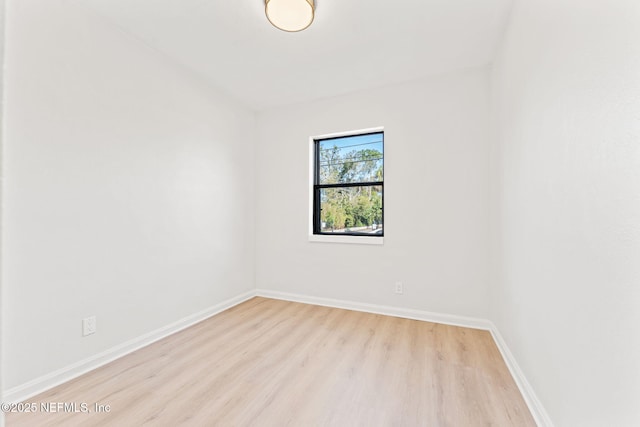 empty room featuring light wood-style floors and baseboards