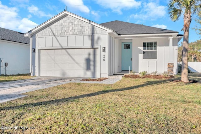 view of front of house with a front yard and a garage