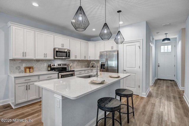 kitchen featuring white cabinetry, stainless steel appliances, and sink