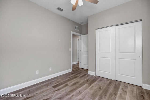 unfurnished bedroom with light wood-type flooring, a closet, and ceiling fan