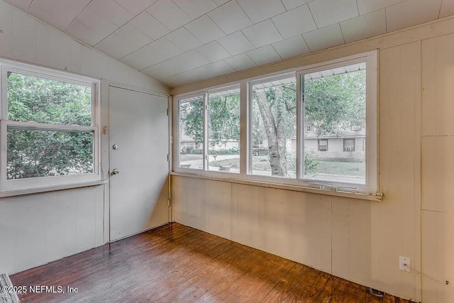 unfurnished sunroom featuring a healthy amount of sunlight and lofted ceiling