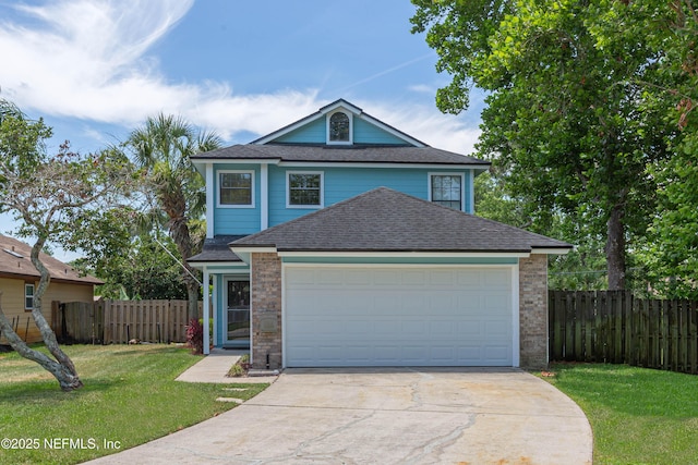 view of front of house with a garage, driveway, a front lawn, and fence